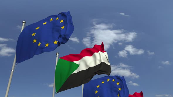 Waving Flags of Sudan and the EU on Sky Background