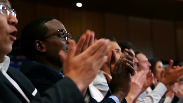 Business Executives Applauding in a Business Meeting