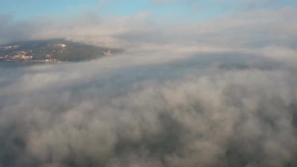 Low clouds over a sea coastline at sunrise