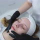 Cosmetologist Applies a Woman a Therapeutic Mask on Her Face - VideoHive Item for Sale