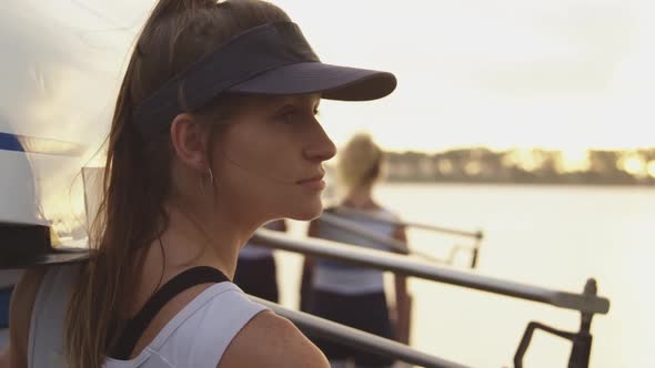 Portrait of female rower by a river