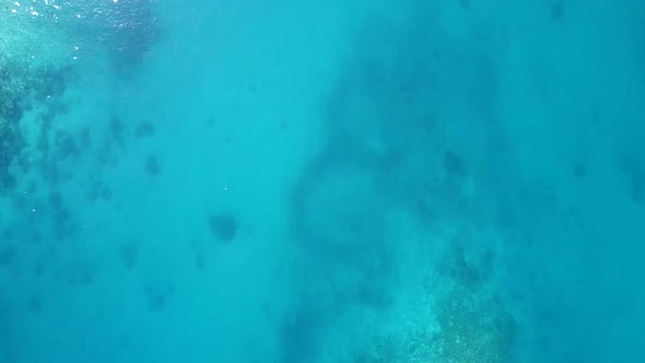 Aerial drone scenery of island beach trip by blue lagoon and sand background