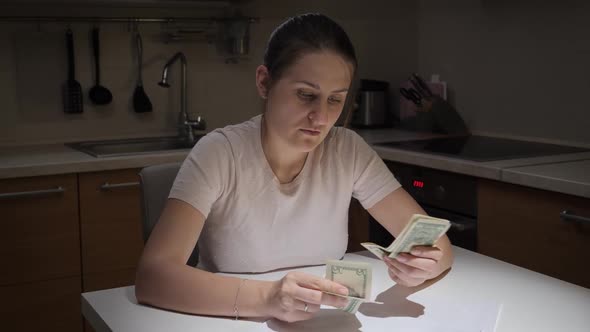 Portrait of Stressed Young Woman Having Financial Problems Counting Her Few Money