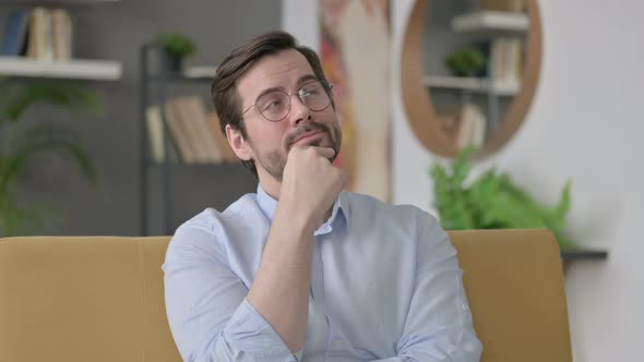 Portrait of Young Man Thinking at Home