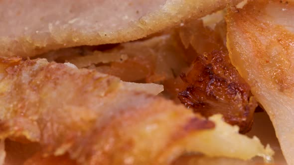 Very close shot of gyro kebab meat fast food. Shawarma meat pieces, close up view in rotating motion