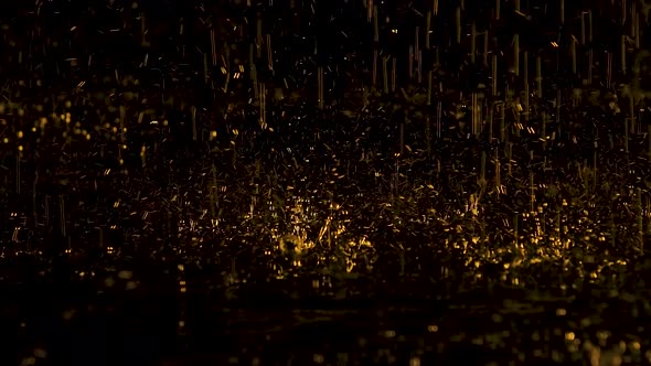 Large Yellow Raindrops Drum on the Water and Bounce To the Sides Creating Splashes. Dark Studio with