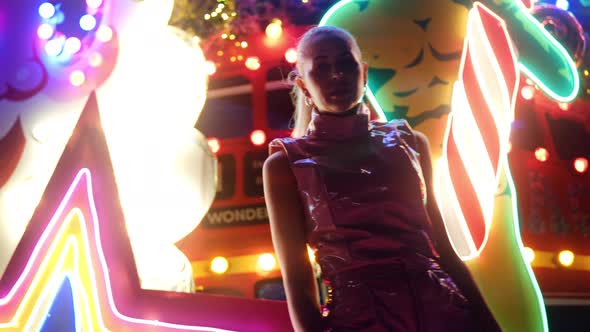 Woman In Pvc Clubwear Dancing Moving And Posing In Front Of Neon