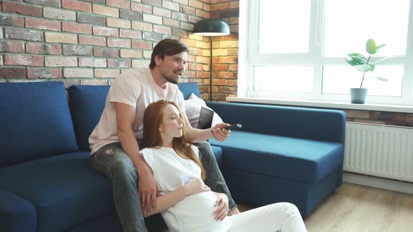 Young Married Couple Watch Tv Together at Home