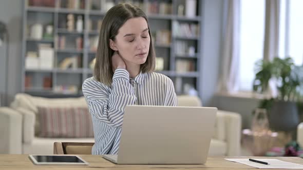 Hardworking Young Woman Having Neck Pain in Office