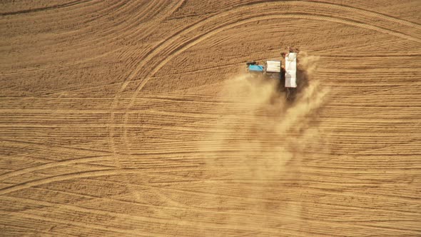 4K Aerial View Tractor With Seed Drill Machine Sowing Seeds For Crops In Spring Season