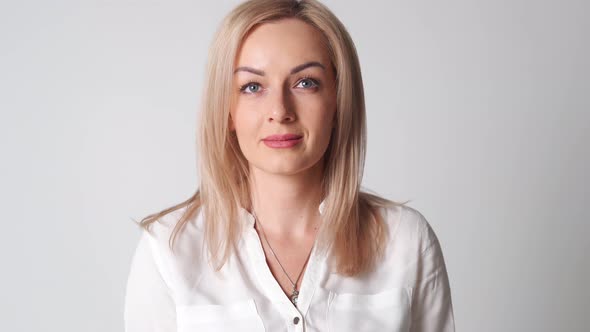 Caucasian Woman with Blond Hair in White Shirt Close Up Portrait