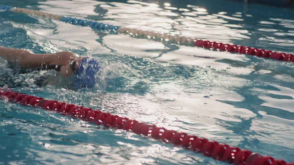 Slowmo of Female Swimmer Practicing Backstroke