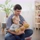 Father playing with his baby son with teddy bear - VideoHive Item for Sale
