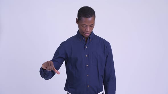 Young Stressed African Businessman Giving Thumbs Down