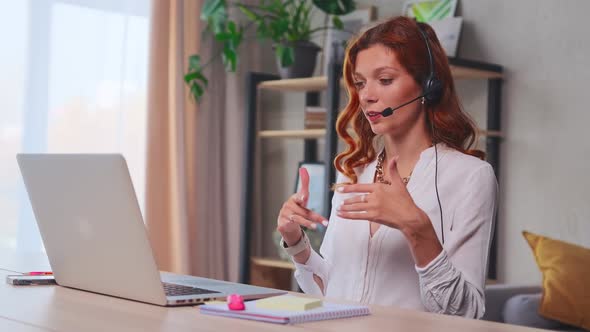 Young Caucasian Business Woman Wearing Headset Communicating By Video Call