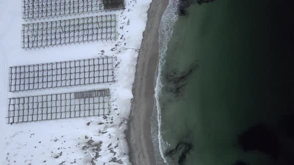 Wooden dry fish racks at hovden Beach Norway Bo in Vesteralen, Bird view shot 4k