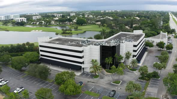 Aerial video orbiting building while rising revealing the surrounding buildings and roads