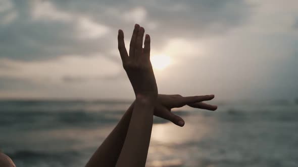 Gentle Woman Hands Move Against Stunning Sunset Over Ocean