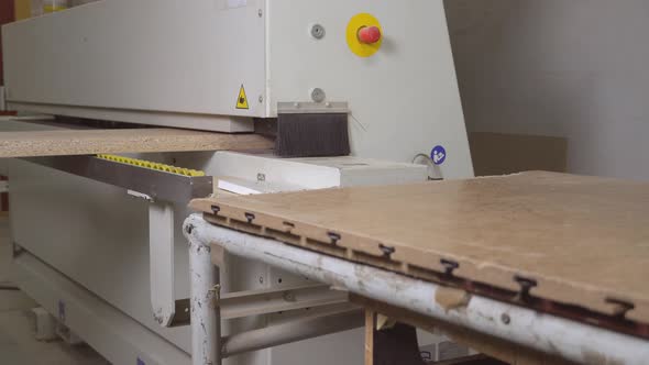 Close-up of a part of a wooden part on an edge-banding machine