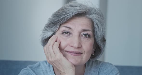 Portrait of a Relaxed and Attractive Elderly Woman in a Home Interior