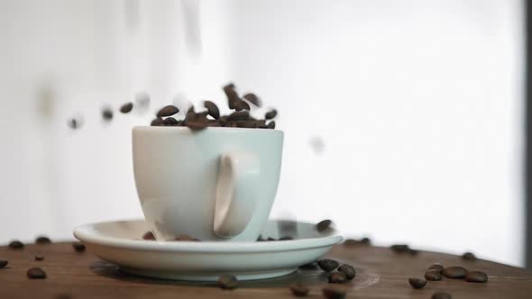 Slow Motion Coffee Beans Fall Into A Coffee Cup, In A Coffee Cup On A Turntable