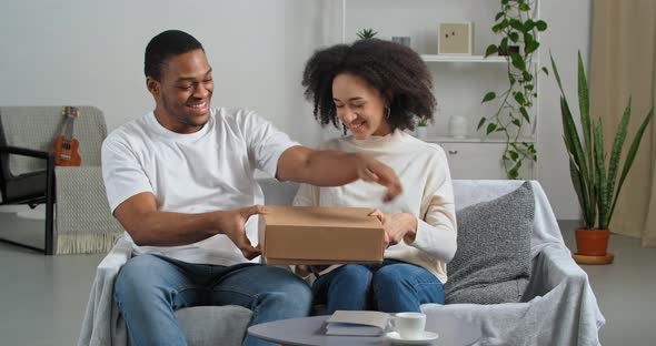 Afro American Couple Black Husband and Wife Consumers Buyers Receive Parcel By Mail From Internet