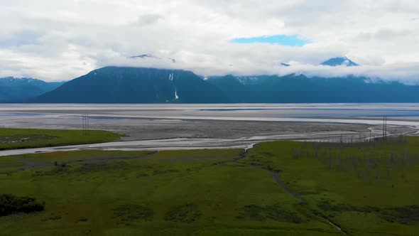 4K Cinematic Drone Video (pedestal down) of Mountains Overlooking Turnagain Arm Bay at Low Tide Near