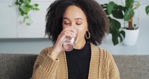 Portrait of Smiling Afro American Woman Ethnic Girl Teenager Sits at Home Interior on Comfortable