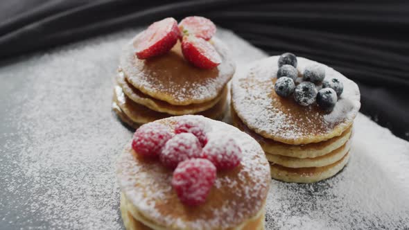 Video of pancakes with fruit on white plate seeing from above