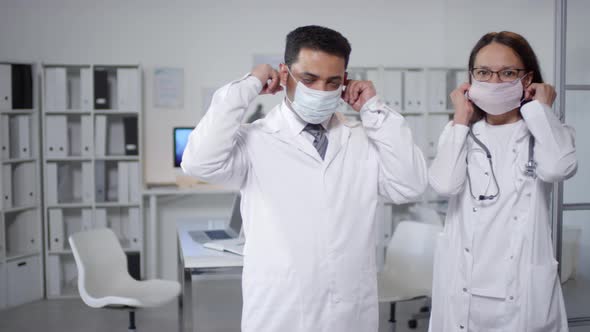 Two Doctors Putting on Masks