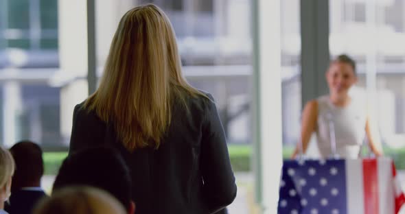 Businesswoman interacting with female speaker in a political campaign 4k