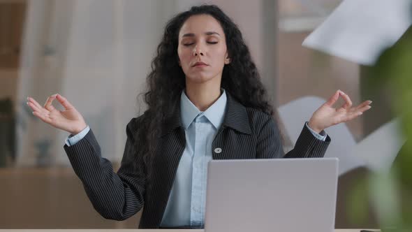 Calm Mindful Female Business Woman Boss in Lotus Position Taking Break Meditating Background of