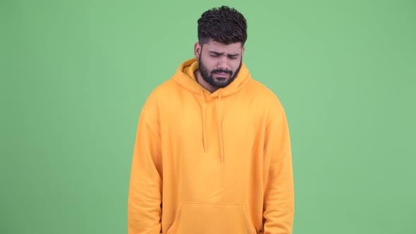 Stressed Young Overweight Bearded Indian Man Looking Sad and Crying