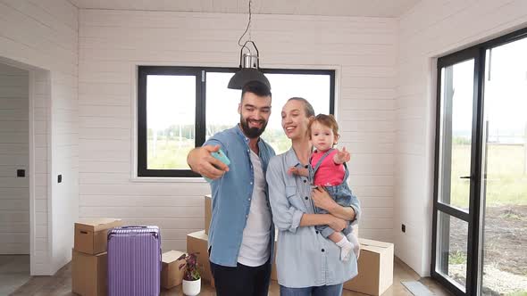 Young Family Just Moved Into a New Home, Dad Takes a Selfie of His Family in a New Home