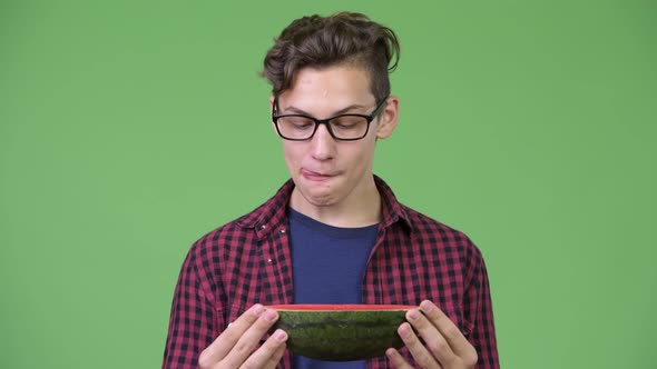 Young Handsome Teenage Nerd Boy with Slice of Watermelon