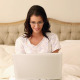 Beautiful Brunette Using Her Laptop In Bed - VideoHive Item for Sale