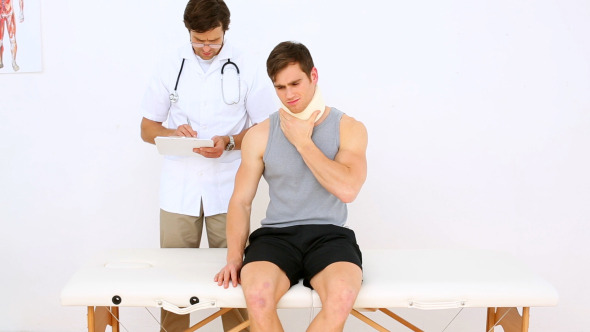 Physiotherapist Talking To Patient Wearing