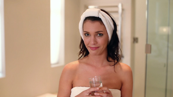 Beautiful Brunette Wearing A Towel Drinking