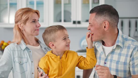 Friendly Family Loving Parents with Their Adorable Little Son Holding Fish in Their Hands Have Fun