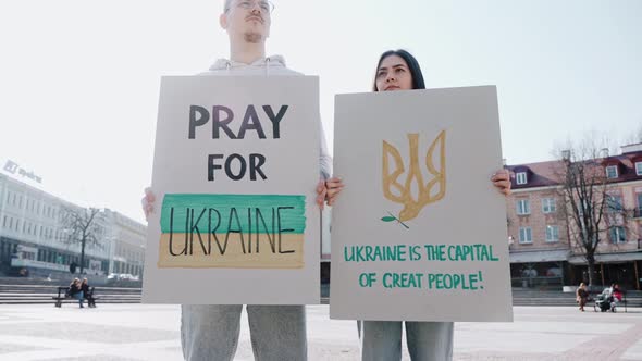 Young People Stand on the Street with Posters Calling to Stop the War in Ukraine