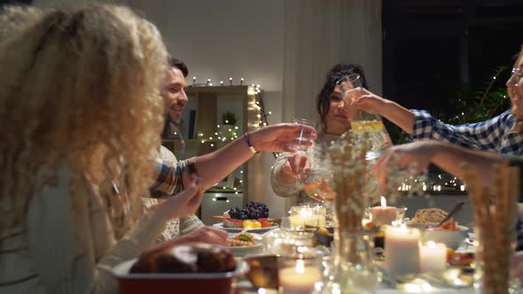 Happy Friends Having Christmas Dinner at Home