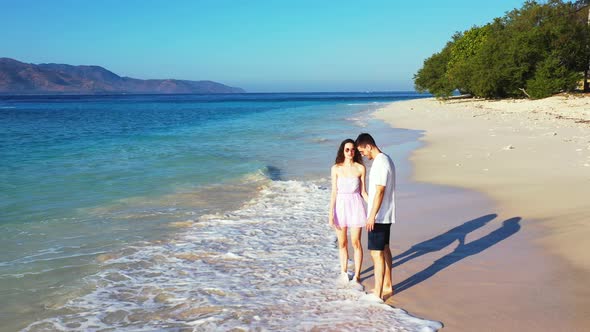 Fun lady and man in love dating on vacation live the dream on beach on white sand background 4K