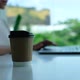 Closeup of a woman drinking coffee while working and typing on laptop computer keyboard - VideoHive Item for Sale