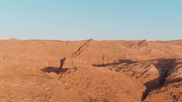 Panning aerial of the vast desert landscape in Utah's Snow Canyon State Park.