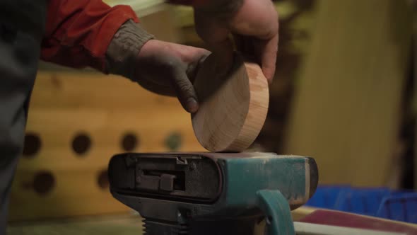 Furniture Factory Worker Processes Polishes a Bar for a Set of Furniture