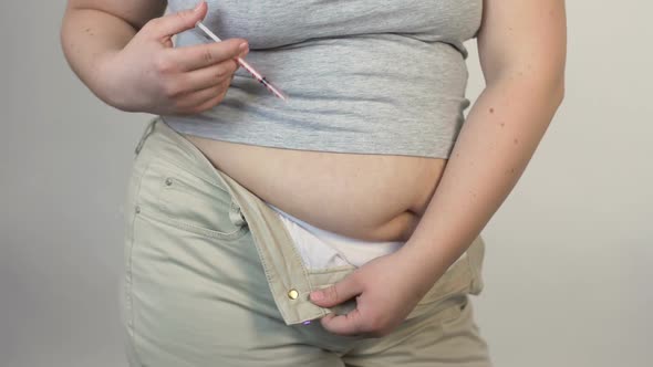 Plus Size Woman Injecting Insulin Into the Stomach, Diabetes, Health Problems