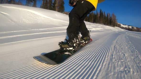 Person shooting vacation activities. Concept of extreme sport nature freeride. Closeup of snowboard