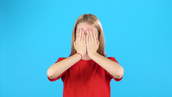 Little Female Covers Her Face with Hands Then Looking with Surprise