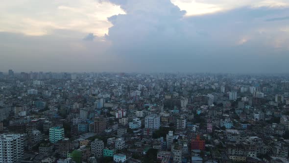 Aerial: metropolitan urban city, densely constructed buildings - establishing top drone descending s