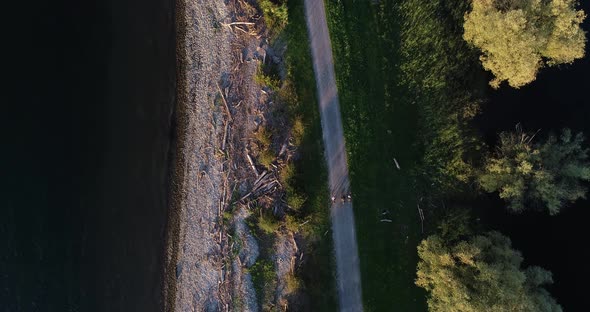 Aerial view of three person cycling a bike along Constance lake, Switzerland.